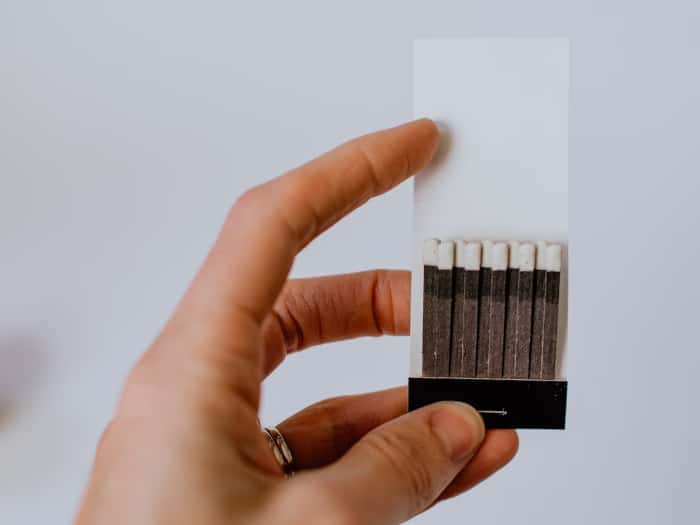 person holding a box of matches